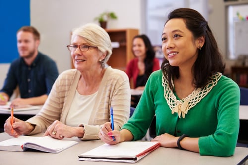 Adults sitting in college class together