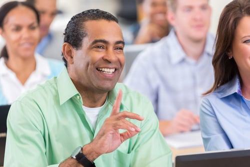 Adult man raising his hand in class