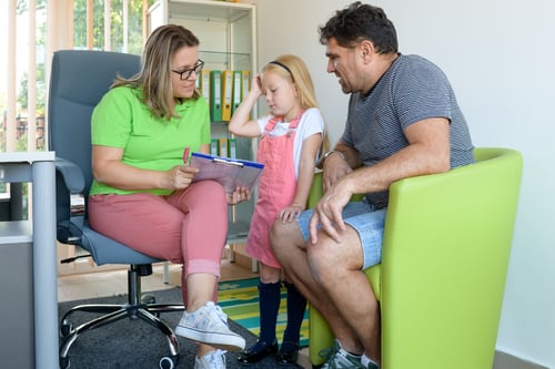 Social worker with a child and her father