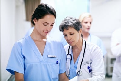 Nurse and doctor talking to each other