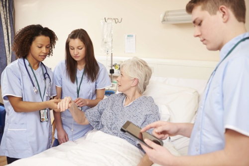 Nursing Students working with an elderly patient